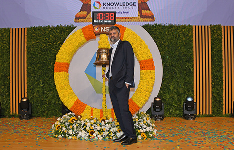 Tuhin Parikh, Head of Real Estate India, Blackstone (co-sponsors), poses for a photo near the bell during the listing ceremony of Knowledge Realty Trust Initial Public Offer (IPO) on the National Stock Exchange (NSE) in Mumbai.