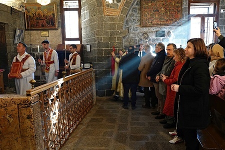 Diyarbakir Metropolitan Municipality Co-Mayor Serra Bucak (right, in a black dress) is seen during the Christmas celebration mass. The small number of Syriac Christians who continue to live in Diyarbakir in Turkey celebrated Christmas with a service at the historic Virgin Mary Church. In Diyarbakir, where thousands of Christians once lived, it is estimated that only around 50 Christians remain due to migration.