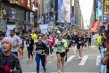 Runners run through Times Square during the 2026 United Airlines NYC Half Marathon on March 15, 2026 in New York City.