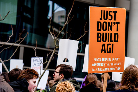 A protestor holds a placard during the "March Against The Machines" Protest. UK activist groups protested against data centre expansion. The demonstrations reflect rising tensions about the climate, energy, and community impacts of data centres being developed to meet increased demand for AI at King's Cross.