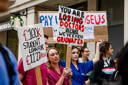Medical students hold placards expressing their opinion during the demonstration outside the Department of Health and Social Care. NHS doctors, nurses, and other allied healthcare professionals gathered outside the Department of Health and Social Care, demanding a pay rise to match the inflation rate. The crowds later marched to Downing Street and demanded the government respond to their demands or else will plan for industrial actions in the coming months.