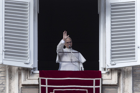 Pope Leo XIV leads the Angelus prayer from the window of his study overlooking St. Peter's Square in the Vatican.
