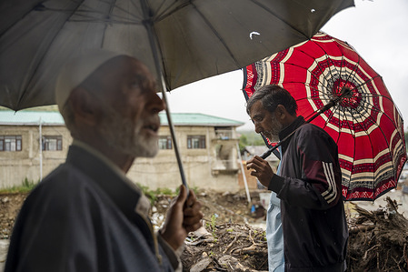 Men holding umbrellas walk along a road during heavy rainfall. Heavy rains and cloudbursts triggered flash floods and landslides at several places across Jammu and Kashmir, causing widespread damage to homes, roads and other infrastructure. Water levels in rivers, streams and other water bodies have risen following incessant rainfall, raising concerns about further flooding. At least one person was killed in Kashmir, while 28 people were reportedly killed in separate rain-related incidents across the Jammu region.