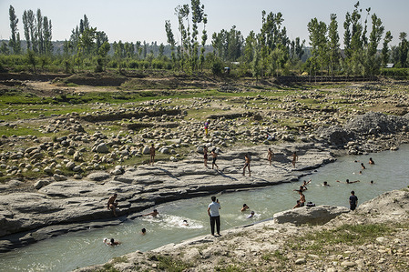Kashmiri boys take bath in a stream to cool off from the scorching heat on a hot summer day in the outskirts Srinagar. The Himalayan region of Kashmir is experiencing an unusual heatwave in June, with Srinagar, the summer capital of Jammu and Kashmir, recording its highest temperature in the last two decades at 35.2 degrees Celsius (96.36 degrees Fahrenheit). Local weather office has advised residents to avoid outdoor activities during peak hours, stay hydrated, and take necessary precautions to cope with the ongoing heatwave.