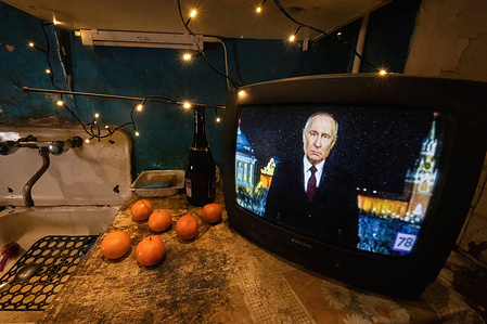 Russian President Vladimir Putin is seen on television delivering his New Year's address to the Russian populace on the eve of 2024.