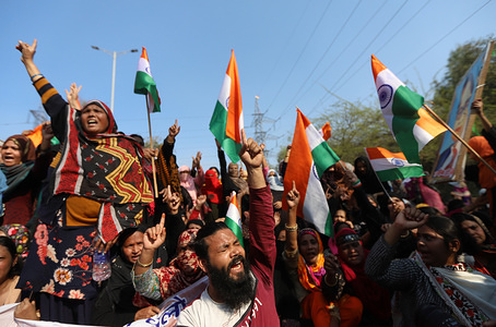 Protesters chant slogans while making gestures during the demonstrations against the new Citizenship Amendment Act 2019 at Shaheen bagh in New Delhi.