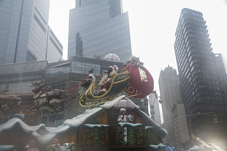 Santa Claus and Elfs seen on Santas Sleigh float during the Macy's Annual Thanksgiving Day Parade in New York City.