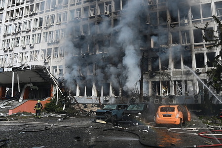 Firefighters work at the site of a business center hit by a Russian drone strike, amid Russia's attack on Ukraine. Russia massively shells Kyiv with missiles and drones. At least eight people were injured, and one died in the hospital. Explosions echoing across downtown Kyiv every 15 to 30 minutes. Air attacks triggered fires at a gas stations, transport enterprises and warehouses. Drone strikes hit civilian and infrastructure objects in the Holosiivskyi and Solomyanskyi districts which left four victims hospitalized.