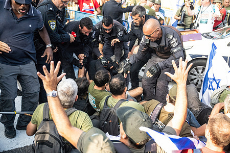 Israeli police officers disperse protesters from the road during a demonstration. "Brothers in Arms", an Israeli reservists organization, gathered to demonstrate against the judicial overhaul in front of Bezalel Smotrich - Minister of Finance house in the occupied West Bank settlement of Kedumim. Police officers responded to the area and dispersed the demonstrators.