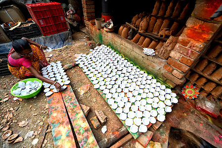 A worker seen drying out the earth lamps ahead of Diwali Festival in India. Deepavali or Dipavali is a four-five day-long festival of lights, which is celebrated by Hindus, Jains, Sikhs and some Buddhists in every autumn all over the world.