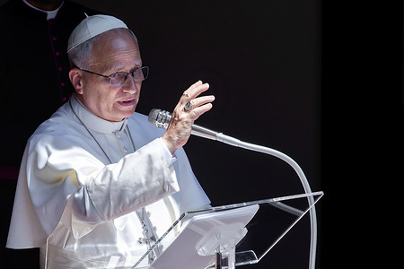 Pope Leo XIV gives his blessing during his Angelus prayer from the apostolic palace of Castel Gandolfo, near Rome.