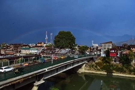 A view of rainbow over old city in Srinagar, Indian administered Kashmir.