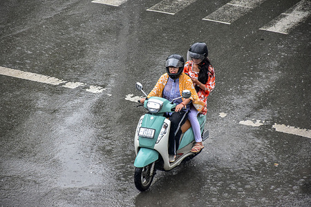 A woman rides along the road during rainfall in Srinagar. At least 67 people have been killed and dozens more remain missing after two incidents of cloudburst unleashed torrential rain in Jammu and Kashmir. 
Meanwhile, moderate to heavy rains lashed wide parts of Kashmir prompting authorities to set up emergency control rooms in vulnerable parts of the valley, officials said.