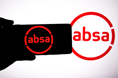 In this photo illustration, an absa group logo is seen displayed on a smartphone and in the background.