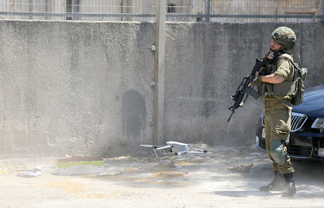 An Israeli soldier operates a drone for security surveillance during a raid on the central fruit and vegetable market east of Nablus in the West Bank. The market is under heavy guard by Israeli forces. This coincided with a security raid carried out by an Israeli intelligence officer on the central market, as part of a broader security operation that included raids on a number of fruit shops.
