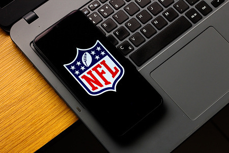 In this photo illustration, the National Football League (NFL) logo is seen displayed on a smartphone screen.