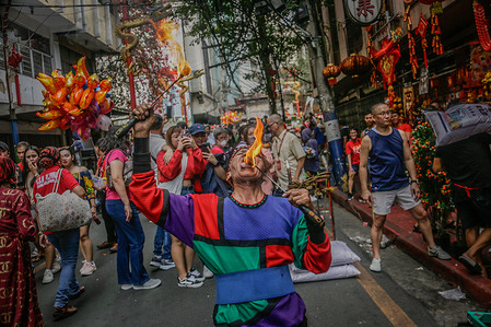 A man performs on the streets of Chinatown to celebrate the arrival of the Chinese New Year. Chinese New Year, also known as the Spring Festival, marks the start of a new year on the traditional Chinese calendar and is one of the most significant holidays in Chinese culture. In the Philippines, the Filipino-Chinese community in Binondo, Manila's Chinatown District, celebrates Chinese New Year with parades and dragon dances along the streets. Established by the Spaniards in 1594, Binondo is the oldest Chinatown in the world.