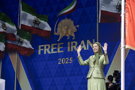 Maryam Rajavi waves to the crowd in front of the Free Iran 2025 stage backdrop. Tens of thousands of Iranians and international dignitaries gathered at Brussels' iconic Atomium for the “Free Iran” rally, marking the 60th anniversary of the People's Mojahedin Organization of Iran (PMOI). Maryam Rajavi, President-elect of the National Council of Resistance of Iran (NCRI), delivered the keynote speech, joined by former U.S. Vice President Mike Pence, former Belgian Prime Minister Guy Verhofstadt, former UK Commons Speaker John Bercow, Congressman Patrick Kennedy, and Dr. Alejo Vidal-Quadras. The rally called for regime change in Iran through Rajavi’s “Third Option” — neither foreign war nor appeasement, but freedom by the Iranian people and their organized Resistance.