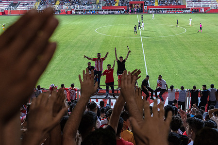 Bats tribune leaders enthuse the fans. Competing in the 2nd league of Turkey, Batman Petrolspor hosted HES Ilac Afyonspor in its 4th match. Batman Petrolspor won the match watched by thousands of fans. Fans of the team in red and white call themselves the Bats. Fans support their team by singing anthems in Turkish and Kurdish.
