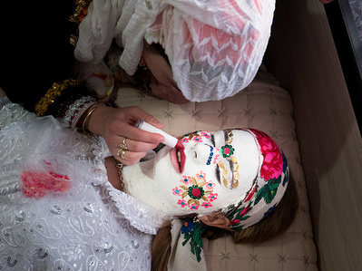 The bride seen having her makeup done for the wedding.
Kimike Inuz is 18 years old and today is her wedding. She comes from Ribnovo, a village of 3000 deep in Rhodope mountains where Pomaks, ethnic Slavs who adopted Islam, live. According to their specific tradition, during a wedding ceremony with imam, the bride comes with her face painted and eyes closed. This tradition is specific for this one village only.