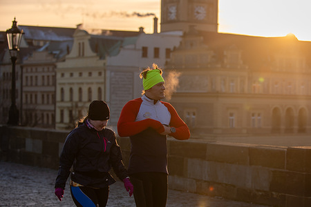 A couple of runners seen jogging on the iconic Charles bridge in the historical part of the Prague during freezing winter morning. Czech Hydrometeorological Institute issued a severe frost warning for the current week in the Czech Republic.