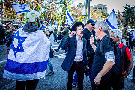 An Ultra orthodox youth argues with a protestor from the Brothers in Arm reserve soldiers movement during a protest against the Judicial reform in the Ultra orthodox city of Beni Brak east of Tel Aviv. Israeli protesters held demonstrations against a contentious government plan to overhaul the judiciary, pushing back against Prime Minister Benjamin Netanyahu after he rejected a compromise proposal that was meant to defuse the crisis.