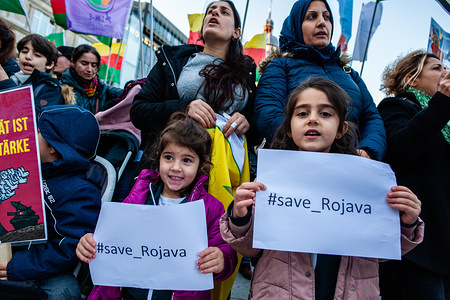 Two little girls hold placards with the hashtag save Rojava during the demonstration.
Thousands of people gathered at the Cologne central station to protest against Turkey's invasion of the Kurdish-liberated democratic autonomous territories in northern and eastern Syria, popularly known as Rojava. The demonstration was surrounded by the riot police when spontaneously started to march.