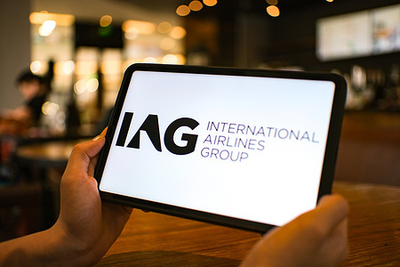 In this photo illustration, the International Airlines Group (IAG) logo is seen displayed on a tablet screen.