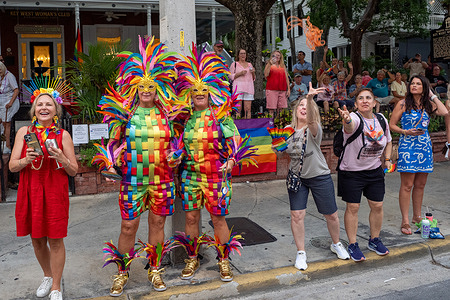 Revelers watch the Pride Parade around the streets.