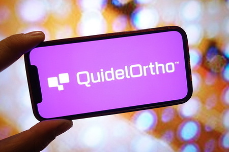 In this photo illustration, a QuidelOrtho company logo is seen displayed on a smartphone screen.