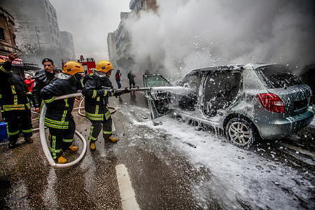 Civil defense officers extinguish a staged burning car during the training session. Palestinian Civil Defense and Security Officers conducted a training session in the evacuation and confrontation of risk in the city of Nablus in the West Bank.