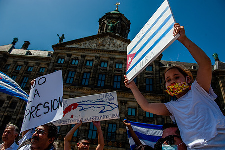 A young Cuban girl holds a placard in support of Cuba during the demonstration.
Cuban people living in The Netherlands organized a peaceful protest at the Dam square in the center of Amsterdam, in support of anti-government protests in Cuba. Cuban citizens have taken to the streets across the country for the first time in more than six decades to protest against deteriorating living conditions and the lack of basic goods and services, including medical attention amid increasing numbers of Coronavirus infections.