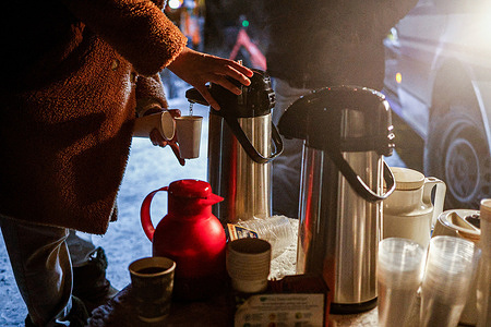 Residents of the Zehlendorf district gather at an outdoor assistance point set up near the S-Bahn station in Zehlendorf, where hot drinks are being distributed and charging facilities for mobile devices are available. The support point was established following a large-scale power outage triggered by an arson attack on power cables at a bridge crossing the Teltow Canal. A deliberate arson attack on high-voltage power cables at a bridge over the Teltow Canal in southwestern Berlin caused a blackout affecting ~45,000 residents in Zehlendorf. The outage disrupted S-Bahn services and prompted authorities to open emergency shelters. Repairs are ongoing.