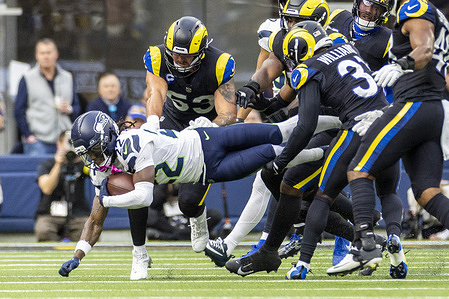 Seattle Seahawks wide receiver Rashid Shaheed (22) is brought down by the Los Angeles Rams during an NFL preseason football game at SoFi Stadium
