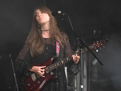 Emillie Key with English contemporary family alternative folk trio Wildwood Kin performs live on stage at Cropredy Festival in Banbury.