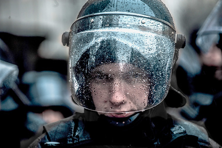 A Police officer seen looking on through his rain spotted face shield during the protest.
Thousands of people turned out to protest against corruption within the military and police force under the Presidency of Petro Poroshenko who is up for reflection at the end of March.
