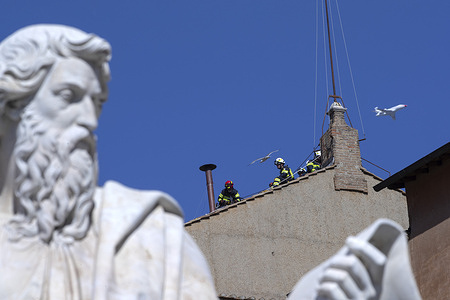 Firefighters install the chimney on the roof of the Sisitine Chapel at the Vatican, smoke will come out of the chimney announcing the choice of the new Pope.
