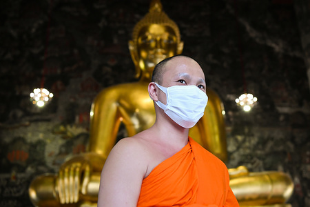 BANGKOK, THAILAND - MARCH 17, 2020:
A Thai Buddhist monk wear a face mask to protect himself against the coronavirus (Covid-19). For most people, the new coronavirus causes only mild or moderate symptoms, such as fever and cough. For others, especially older adults and people with existing health problems, it can cause more severe illness, which can lead to death.
30 new cases of the Covid-19 has been confirmed by the Public Health Ministry of Thailand today, which now raised the total number of infections to 177 since the beginning of the outbreak.