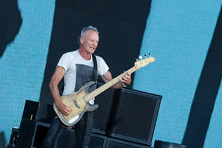 Gordon Matthew Thomas Sumner, known professionally as Sting, former front man with British rock and pop band, The Police, performs live on stage with his backing band at the Isle of Wight Festival.