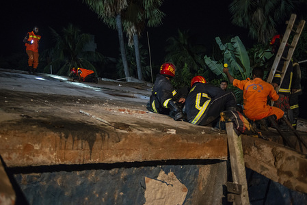 Members of the Fire and Rescue with volunteers looking for a trace of the missing boy.
A four storied building collapse beside it's pond in Narayanganj killing a 12 year old boy and one missing, 10 years old. Locals says the building was inappropriate.