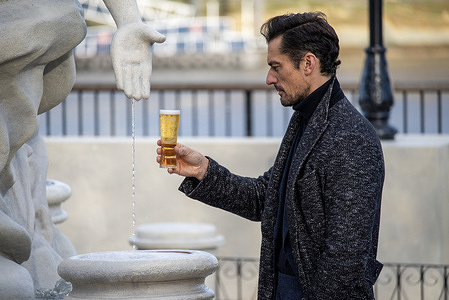The English model, David Gandy looks at his beer during the filming at the South Bank in London. Premium beer, Peroni Nastro Azzurro, the UK's most loved beer unveiled the La Fontana di Azzurro 'turning water into beer' by the English model David Gandy at the Observation Point in South Bank, London. The occasion will be open to the public from the 10th-14th December 2025 to bring holiday cheer to the nation.