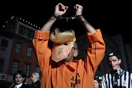 A participant in the New York Halloween parade is dressed up as Donald Trump.

The 51st Annual Village Halloween Parade took place in New York's West Village, marching down Sixth Avenue in Manhattan, New York. This year’s theme, “Meow,” invited participants to embrace all things feline, showcasing a wide array of cat-inspired costumes. Live music and performances added to the festive atmosphere. This year, the parade took on a political tone just days before the presidential elections, with costumes caricaturing Republican candidate Donald Trump.