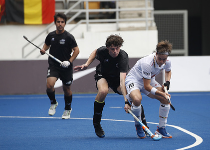 Matthew Wilson of New Zealand (C) and Maximilian Langer of Belgium (R) in action during the FIH Hockey Men's Junior World Cup Malaysia 2023 match between Belgium and New Zealand at Bukit Jalil National Hockey Stadium. Final score; Belgium 4:0 New Zealand.
