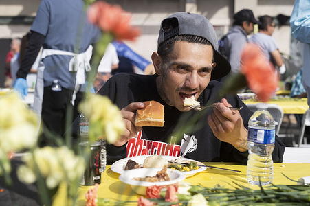 A man enjoys his Thanksgiving meal. Thousands of Skid Row residents and homeless people from downtown and beyond were served Thanksgiving dinners during the Los Angeles Mission's annual holiday feast.