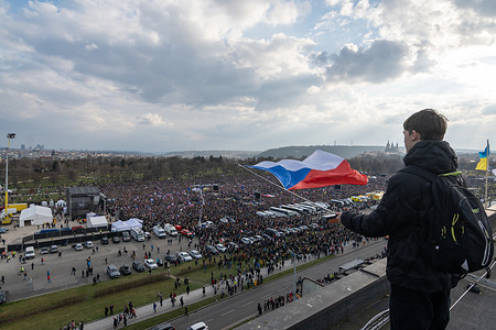 A protester holds a Czech flag during a rally called We will not let our future be stolen, organized by Million Moments for Democracy (Milion Chvilek pro Demokracii in Czech language) group. People held protests against current plans and politics of Czech government and Czech coalition majority in parliament. According to the organisers more than 250 thousand people took part in the demonstration.