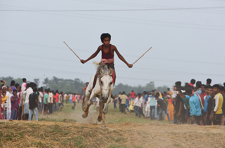 Children Jockeys ride horses without proper safety equipment's during a Horse Race in Rural Bengal.