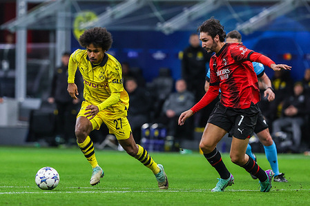 Karim Adeyemi of Borussia Dortmund (L) and Yacine Adli of AC Milan (R) and scores a goal during the UEFA Champions League 2023/24 Group Stage - Group F football match between AC Milan and Borussia Dortmund at San Siro Stadium. Final score: Borussia Dortmund 3 : 1 AC Milan.