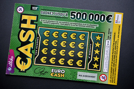 In this photo illustration, a "Cash" scratch card seen before being scratched. The "Cash" scratch card game from Française des Jeux (FDJ) is getting a new look. Still priced at €5, it offers the luckiest players the chance to win up to €500,000.