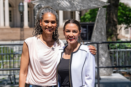 Mayoral candidate Maya Wiley and United States Congresswoman Alexandria Ocasio-Cortez pose with City Hall in background in New York City. 
Representative Alexandria Ocasio-Cortez, one of the most prominent left-wing leaders in the country, endorsed Maya D. Wiley in the race for New York City mayor.  Representative Ocasio-Cortez's endorsement may cement Ms. Wiley as the left-wing standard-bearer in the New York City mayor's race.