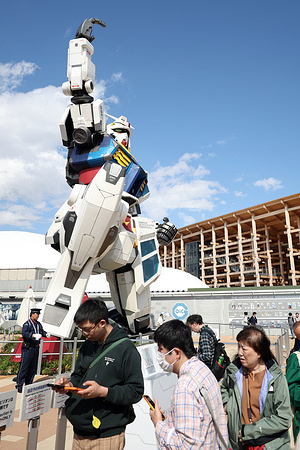 A crowd of visitors takes photos of the towering Gundam at the Osaka-Kansai Expo 2025. Osaka-Kansai Expo 2025 is a world exposition in Japan focused on designing a future society that promotes health, sustainability, and innovation. It will be held from April 13 to October 13, 2025.